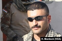 Iraqi Army Captain Raad Qasim says his battalion is moving forward slowly, trying to avoid killing civilians sometimes handcuffed to militants as they retreat on Nov. 19, 2016 in Mosul, Iraq.