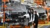FILE - GMC Hummer EVs are seen on an assembly line at he General Motors Factory ZERO electric vehicle assembly plant in Detroit, Michigan, Nov. 17, 2021.