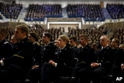 Members of the U.S. Naval Academy listen as Sen. John McCain, R-Ariz., is introduced by former Sen. John Warner, R-Va., at the Academy in Annapolis, Maryland, Oct. 30, 2017.