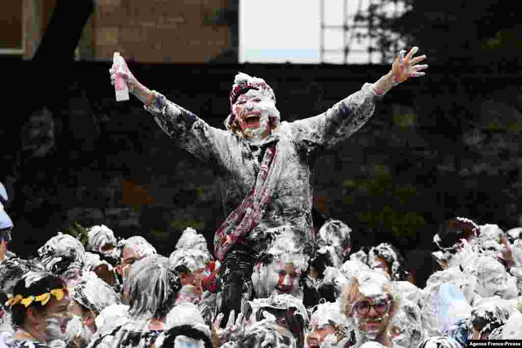 First year students of the University of St. Andrews participate in the annual Raisin Monday shaving foam fight on the Lower College Lawn in St. Andrews, eastern Scotland.