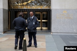 Police and security stand outside 30 Rockefeller Plaza, the location for the offices of U.S. President Donald Tump's lawyer Michael Cohen which was raided by the FBI in the Manhattan borough of New York City, New York, April 9, 2018.