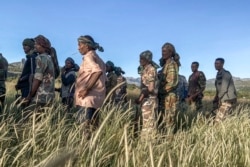 FILE - Amhara militia men, that combat alongside federal and regional forces against northern region of Tigray, receive training in the outskirts of the village of Addis Zemen, north of Bahir Dar, Ethiopia, Nov. 10, 2020.