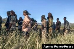 FILE - Amhara militia men, that combat alongside federal and regional forces against northern region of Tigray, receive training in the outskirts of the village of Addis Zemen, north of Bahir Dar, Ethiopia, Nov. 10, 2020.