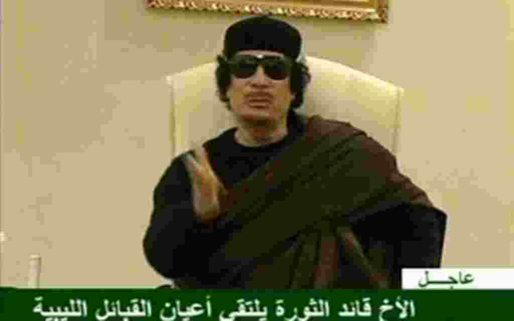 Still image from a video shows Gaddafi gesturing as he speaks at a Tripoli hotel