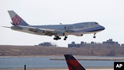 FILE - A China Airlines cargo jet lands at John F. Kennedy International Airport, March 14, 2020, in New York. 