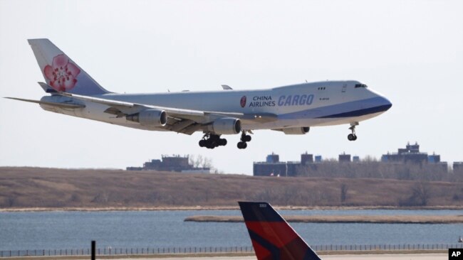 FILE - A China Airlines cargo jet lands at John F. Kennedy International Airport, March 14, 2020, in New York.