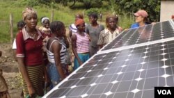 FILE: Photovoltaic cells in the solar panels, such as these in a village in Benin, convert sunlight into electricity. Taken August 20, 2012. 