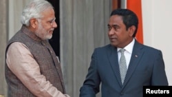 File - India's Prime Minister Narendra Modi (L) shakes hands with Maldives President Abdulla Yameen before the start of their bilateral meeting in New Delhi.