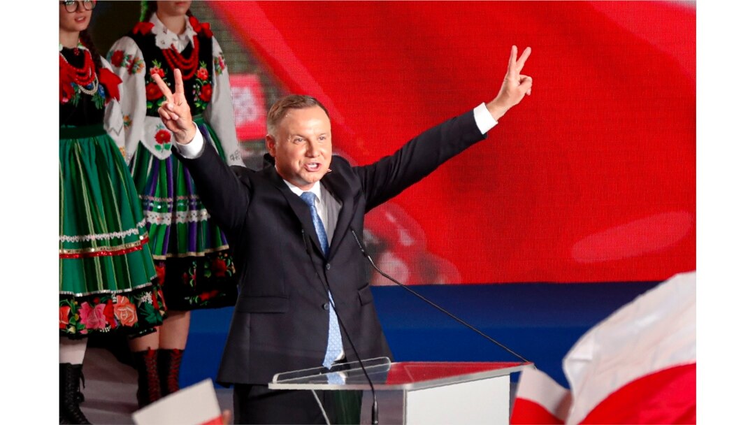 President Andrzej Duda flashes victory signs after voting ended in the presidential election in Lowicz, Poland, Sunday, June 28, 2020.
