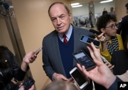 FILE - Reporters seek a comment from Sen. Richard Shelby, R-Ala., on Capitol Hill in Washington, Dec. 12, 2017.