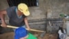 Una mujer trabaja la tierra junto a su nieto a las afueras de Caracas, Venezuela.