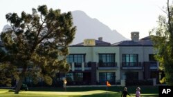 Morning golfers at the Arizona Biltmore resort walk off a green, Oct. 27, 2021, in Phoenix, Arizona.