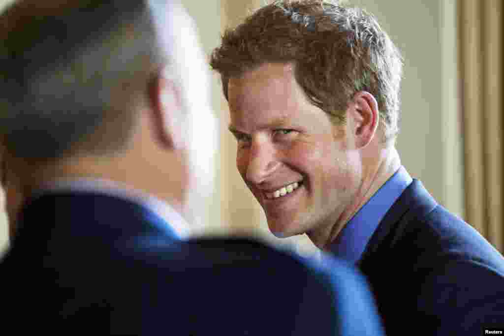 Britain's Prince Harry greets attendees before a reception in the Prince's honor at the Ambassador's residence in Washington May 9, 2013. Prince Harry kicked off his visit to the US with two days in the nation's capitol. REUTERS/Jim Lo Scalzo/Pool (UN