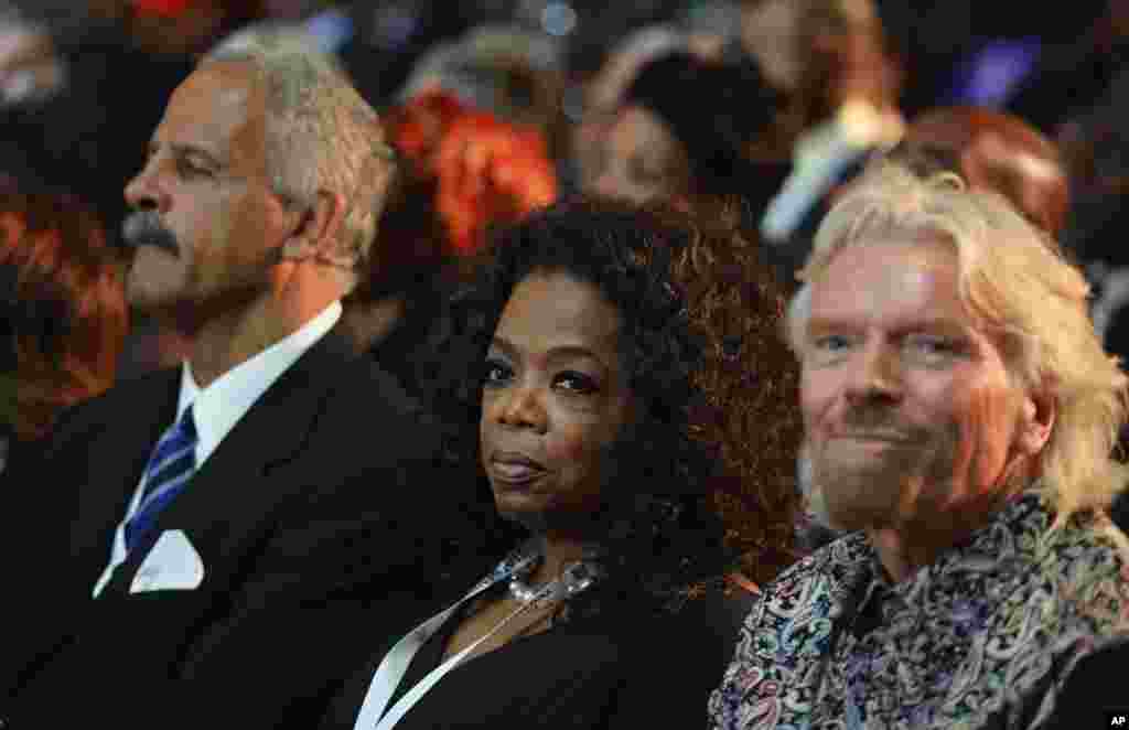 British entrepreneur Richard Branson, right and television host Oprah Winfrey attend the funeral service for former South African President Nelson Mandela in Qunu.