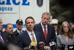 Mayor Bill de Blasio looks on as Gov. Andrew Cuomo delivers remarks during a news conference after NYPD personnel removed an explosive device from Time Warner Center, Oct. 24, 2018, in New York.