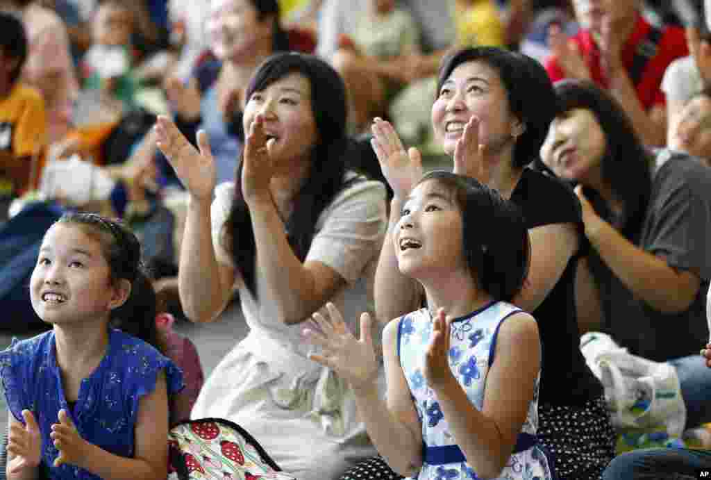 Visitors watch NASA&#39;s live broadcast of Soyuz TMA-17M hatch&#39;s opening at a public viewing in the National Museum of Emerging Science and Innovation &quot;Miraikan&quot; in Tokyo, Japan, July 23, 2015.