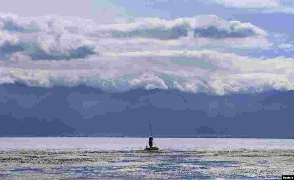 A villager fishes on a platform at the Erhai Lake in Dali, Yunnan province, China. 