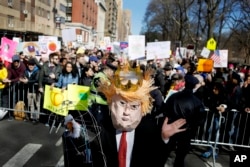A man wearing a Donald Trump costume participates in a rally in New York, Feb. 20, 2017.