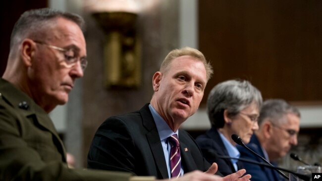 FILE - Acting Defense Secretary Patrick Shanahan, center, accompanied by Joint Chiefs Chairman Gen. Joseph Dunford, left, and Secretary of the Air Force Heather Wilson, speaks during a Senate Armed Services Committee hearing on Capitol Hill in Washington.