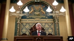 Michigan Gov. Rick Snyder delivers his State of the State address to a joint session of the House and Senate, at the state Capitol in Lansing, Mich., Jan. 19, 2016.