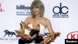 Singer Taylor Swift poses backstage with her awards for Top Artist, Billboard Chart Achievement Award, Top Female Artist, Top Hot 100 Artist, Top Digital Songs Artist, Top Streaming Song (Video) for "Shake it Off" and Top Billboard 200 Album for "1989" during the 2015 Billboard Music Awards in Las Vegas, Nevada, May 17, 2015.