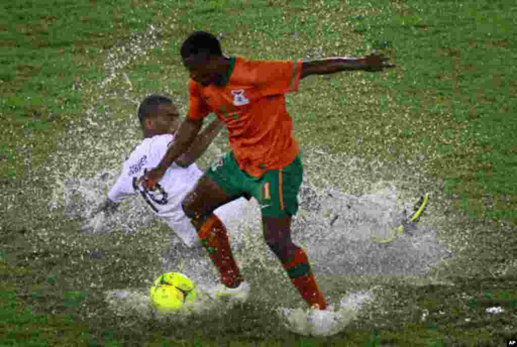 Katongo of Zambia challenges Abubaker al Abaidy of Libya during their African Nations Cup Group A soccer match at Estadio de Bata "Bata Stadium", in Bata