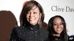 FILE - Whitney Houston and daughter Bobbi Kristina in Beverly Hills, CA, February 12, 2011