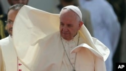 Wind blows Pope Francis' cape during an official welcome ceremony at the Abu Dhabi Presidential Palace, United Arab Emirates, Monday, Feb. 4, 2019.