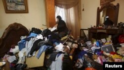 A Palestinian woman inspects the damage to her house, which her family said was searched during an Israeli army raid, following the arrest of a family member by the army in the Askar refugees camp near the West Bank city of Nablus February 23, 2016. 