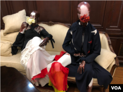 Two outfits from Azede Jean-Pierre's collection on display at the Haitian Embassy in Washington D.C. during a fashion event, Feb. 23, 2018. (VOA / S. Lemaire)
