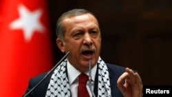 FILE - Turkey's Prime Minister Tayyip Erdogan addresses members of parliament from his ruling AK Party (AKP) during a meeting at the Turkish parliament in Ankara, July 22, 2014. 