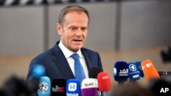 FILE - European Council President Donald Tusk speaks with the media at the Europa building in Brussels, Belgium, April 29, 2017. He was allegedly depicted as an SS officer in an altered photo posted on Facebook by now suspended Polish honorary consul in Akron, Ohio, Maria Szonert-Binienda.