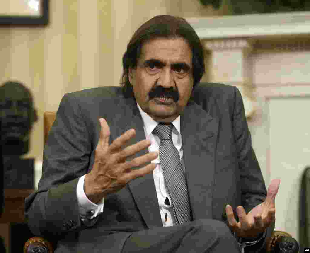 Sheik Hamad bin Khalifa Al Thani of Qatar gestures as he speaks during a meeting with President Barack Obama, not shown, in the Oval Office of the White House in Washington, April 23, 2013.