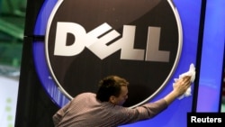 A man wipes a Dell logo at an IT exhibition in Hannover, Germany, in this February 28, 2010, file photo.
