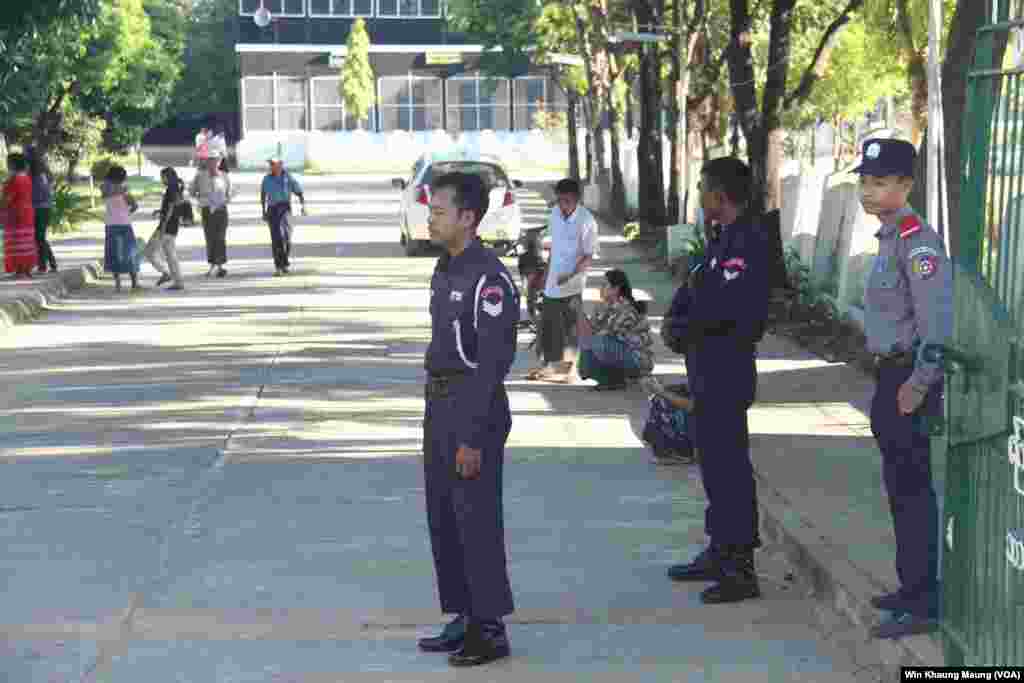 Seen here are a member of police force and members of fire brigades posted outside a polling station. Pyay Township, Nov. 8th, 2015