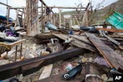 Shoes are scattered among the debris of a home destroyed by Hurricane Matthew, in Port-a-Piment, a district of Les Cayes, Haiti, Oct. 19, 2016.