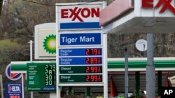 FILE - Gas stations display their prices in Englewood, N.J., April 30, 2018. 