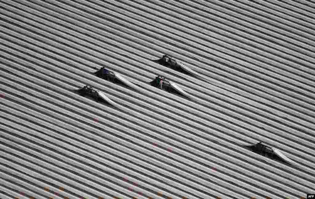 This aerial view shows workers on an asparagus field near Grevenbroich, western Germany.