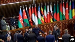 Pakistani Foreign Minister Shah Mahmood Qureshi, center, welcomes guests for the extraordinary session of Organization of Islamic Cooperation (OIC) Council of Foreign Ministers, in Islamabad, Dec. 19, 2021.