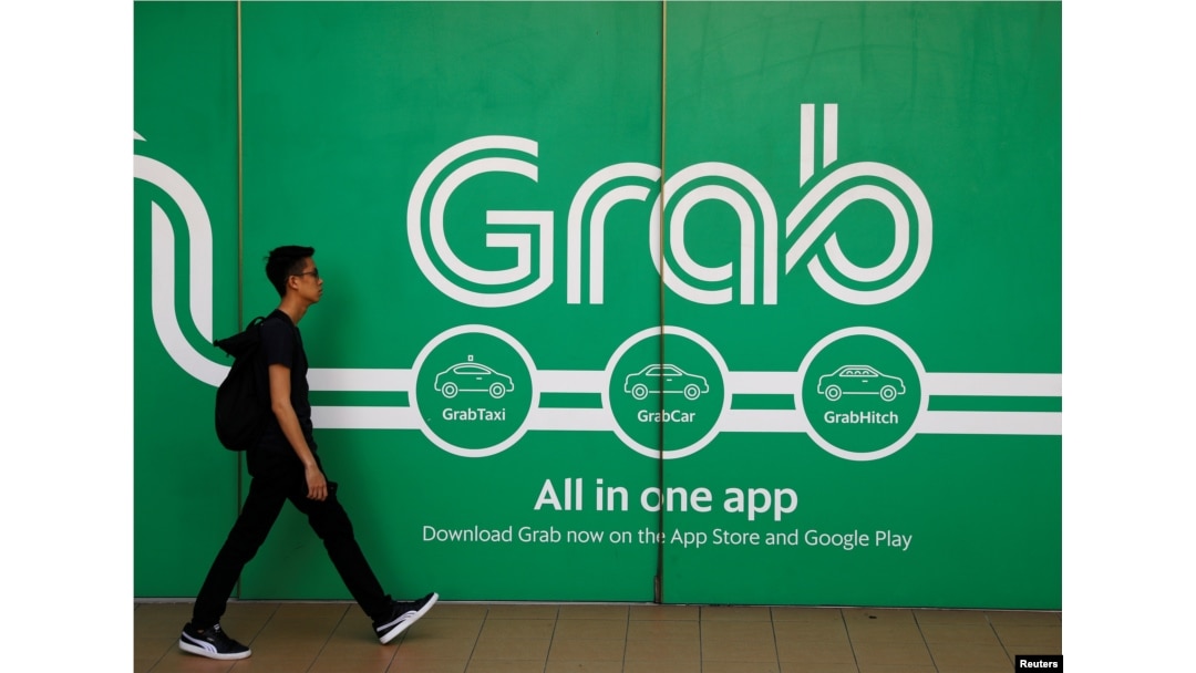 A man walks past a Grab office in Singapore, March 26, 2018.