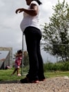 FILE - A woman who said she entered the United States illegally, watches over her daughter, who was born in the U.S., in Sullivan City, Texas, Sept. 16, 2015.