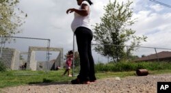 FILE - A woman who said she entered the United States illegally, watches over her daughter who was born in the U.S., in Sullivan City, Texas, Sept. 16, 2015.