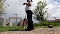 FILE - A woman who said she entered the United States illegally, watches over her daughter, who was born in the U.S., in Sullivan City, Texas, Sept. 16, 2015.