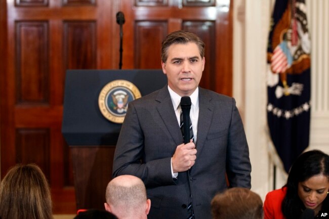 FILE - CNN journalist Jim Acosta does a standup before a new conference with President Donald Trump in the East Room of the White House in Washington, Nov. 7, 2018.