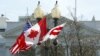 A Canadian flag flutters between a U.S. flag and a Washington, D.C., flag in front of the White House in Washington, March 7, 2016. Preparations are under way for the official state visit of Canada's Prime Minister Justin Trudeau on Thursday. 