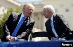 FILE - U.S. President Donald Trump speaks with Attorney General Jeff Sessions as they attend the National Peace Officers Memorial Service on the West Lawn of the U.S. Capitol in Washington, May 15, 2017.