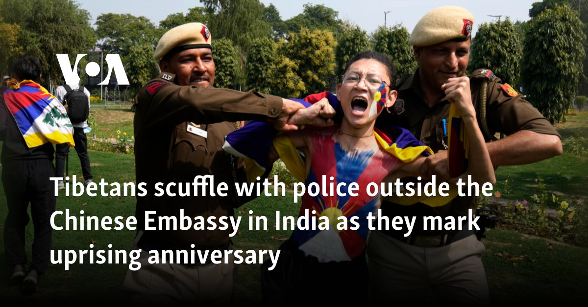 Tibetans scuffle with police outside the Chinese Embassy in India as they mark uprising anniversary