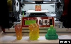 FILE - A 3-D printer for consumers capable of creating multicolor objects is demonstrated at the Consumer Electronics Show in Las Vegas on Jan. 4, 2016.