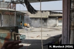 A mortar falls across the street from a make-shift military base on the outskirts of Mosul's Old City, March 29, 2017.