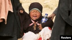 A child cries in the village of Baghuz, Deir el-Zour province, Syria, March 14, 2019. 